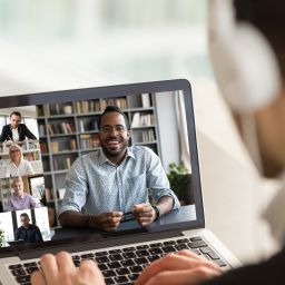 Male employee talk on video call with diverse colleagues