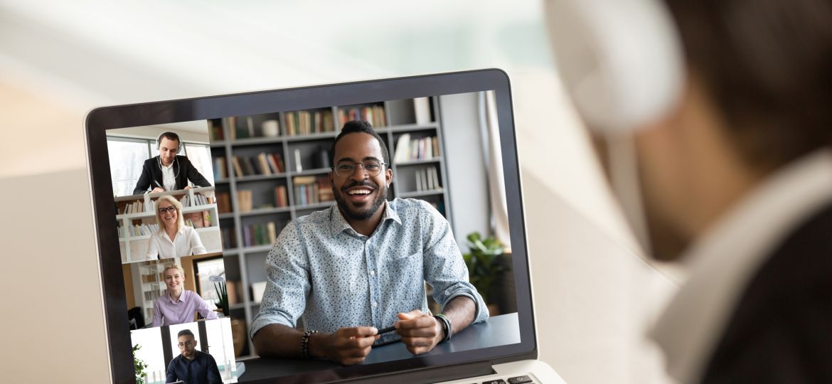 Male employee talk on video call with diverse colleagues