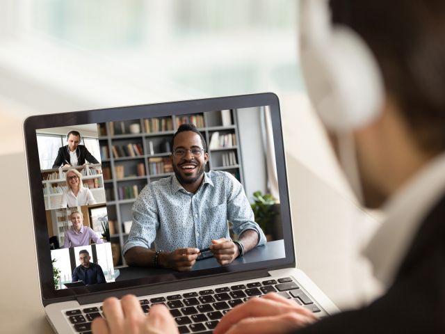 Male employee talk on video call with diverse colleagues